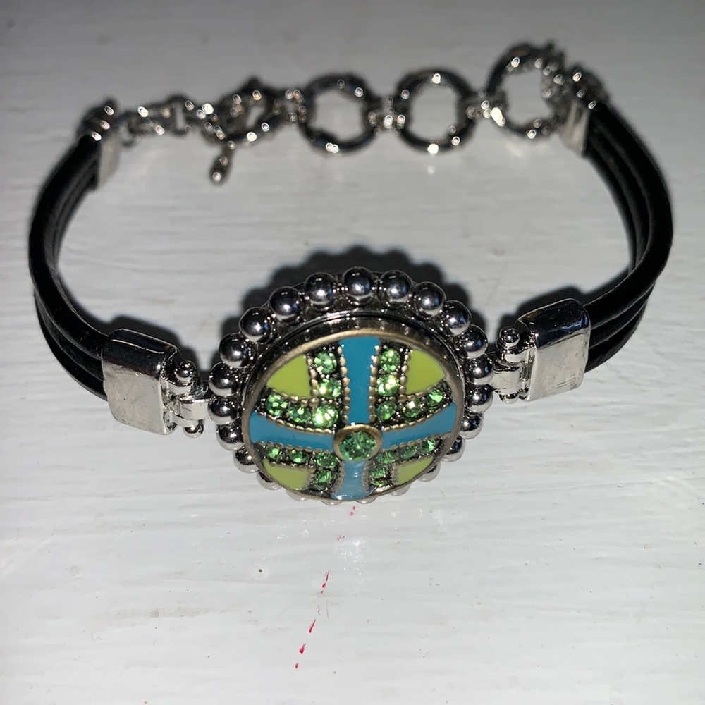 One black embossed leather toggle snap bracelet with one snap.  NWOT